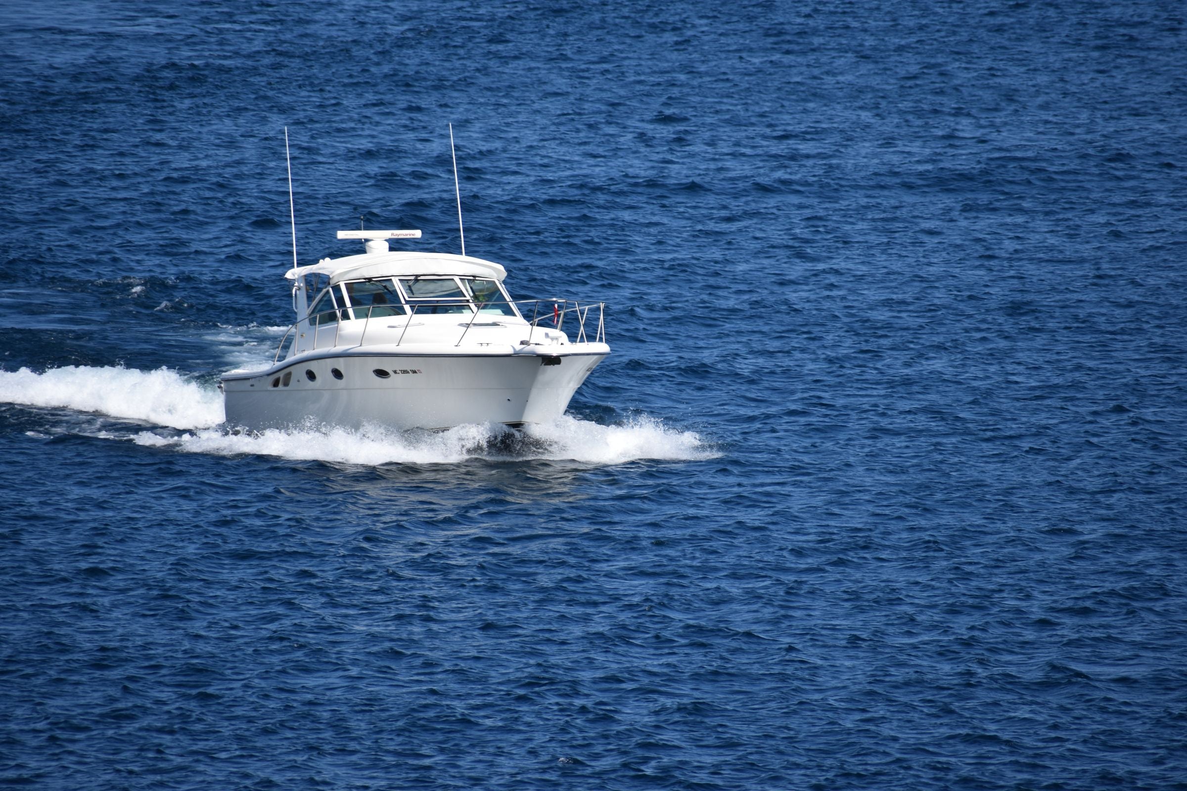 Small cabin cruiser underway on open water